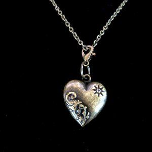 Antiqued brass heart pendant with rhinestone and applied scrollwork - NEW